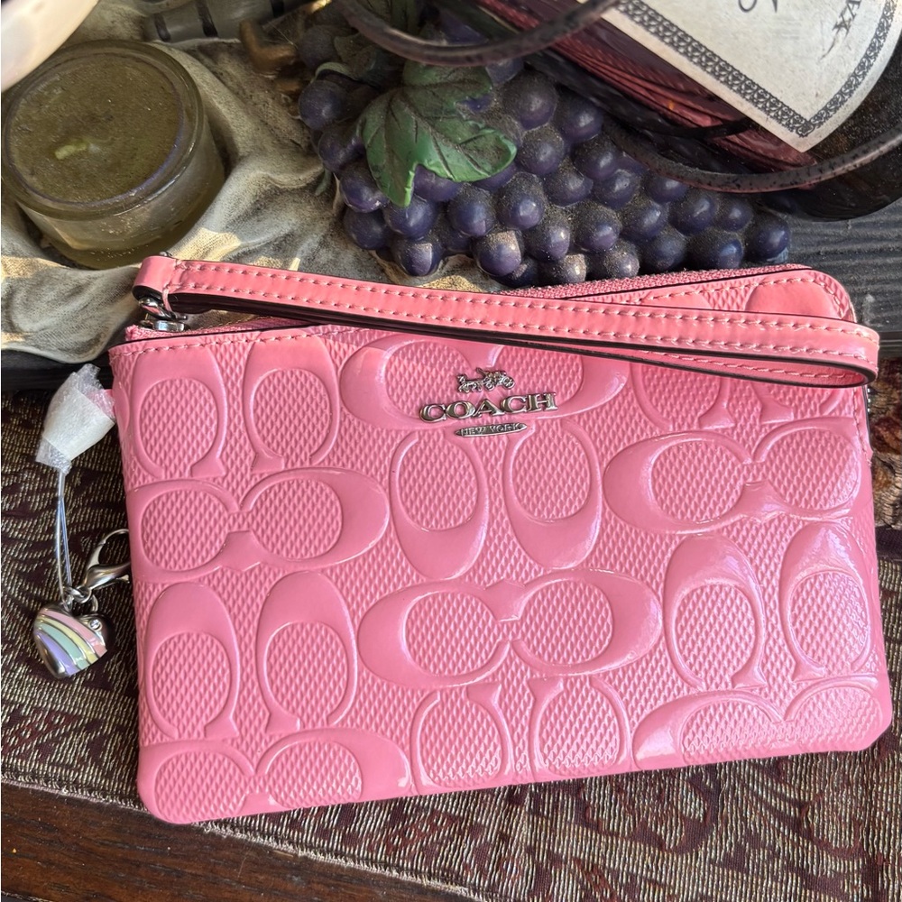 Authentic COACH patent signature leather zip top wristlet with a heart charm